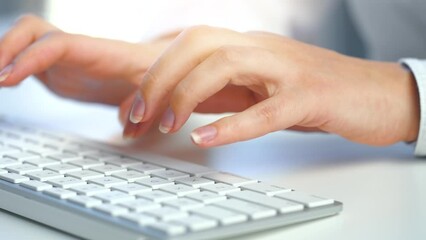 Female hands busy working on computer keyboard for sending emails and surf on a web browser