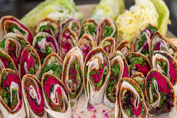 Wall Mural - Wrap sandwich, many rolls with fresh vegetables on a plate