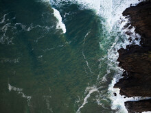 Top View Of The Ocean. Clear Clear Water And Waves Crashing Against The Rocky Shore. The Beauty And Grandeur Of Nature, Beautiful Seascape. Geology, Maps, Ecology.