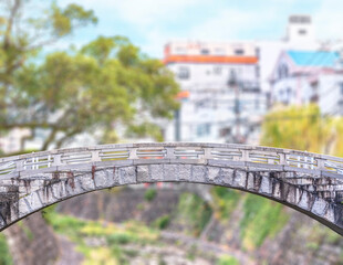 nagasaki, kyushu - december 12 2021: Close up on the Ichiran stone bridge above the Nakashima river against a shallow depth of field blurry background.