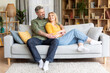 © Prostock-studio - Romantic happy middle aged couple relaxing on couch at home