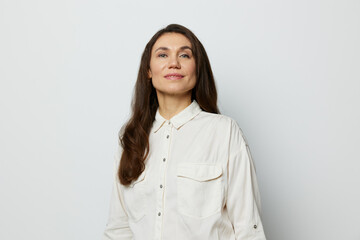 Wall Mural - portrait of a beautiful happy attractive adult woman in a white shirt on a white background