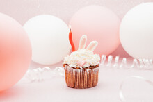Pink Bunny Cupcake And Red Candle On Glitter Pink Background With Air Balloons On Card