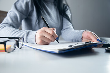 Canvas Print - Woman signing document and hand holding pen