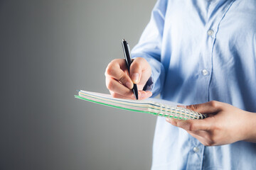 Canvas Print - hand writes with a pen in a notebook