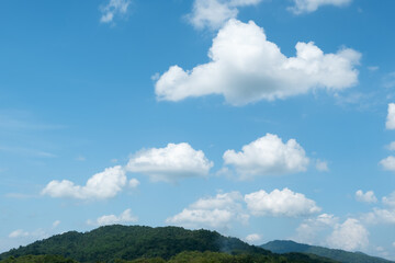 Wall Mural - the white clouds have a strange shape and moutain.the sky and the open space have mountains below.