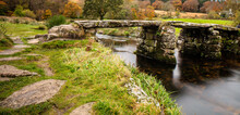 A Clapper Bridge At Postbridge. A Hamlet In Dartmoor National Park. The Bridge Is Believed To Date Back To Medieval Times To Help Packhorses Across The River.