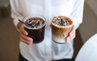 © Farknot Architect - Closeup of a woman holding two glasses of iced coffee