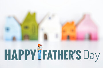 Wall Mural - Happy Father's day card background idea, man holding a boy over blurred colorful miniature house on white background