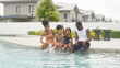 © tampatra - Group of relaxed black african american family, dad, mother and daughter playing by the swimming pool in summer season. People lifestyle in travel holiday vacation concept. Relaxation.
