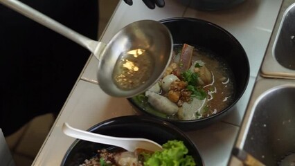 Wall Mural - Stainless steel strainer over the hot noodle 
pot with white smoke from boiling steam in a
kitchen. Thailand street food