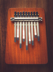 Sticker - Traditional wooden kalimba on a wooden background