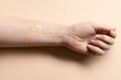 Foundation cream smear test on female hand, CC cream stroke, tinted moisturiser applied on woman hand