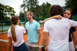 Group of tennis people players giving a handshake after a match