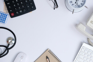 Wall Mural - Office desk with smartphone, laptop computer, cup of coffee, and office tools. Flat lay, top view with copy space. A bank notepad and a pen are on top of an office desk table containing computer tools