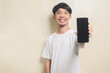 asian man wearing white t-shirt with gesture showing his phone on isolated background
