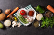 Assortment of vegetables, herbs, spices and heart shaped plate on black background. Top view. Copy space	