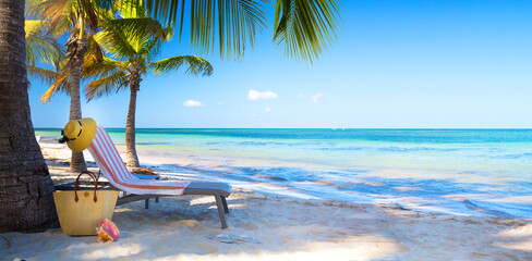 Poster - Art Tropical paradise beach with a sun-lounger facing the blue sea