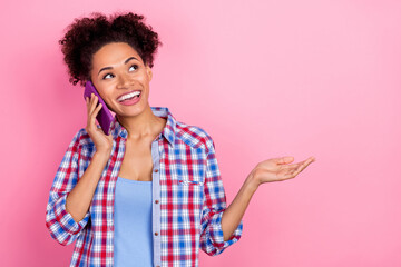 Photo of impressed curly hairdo lady talk telephone wear blue shirt isolated on pink color background