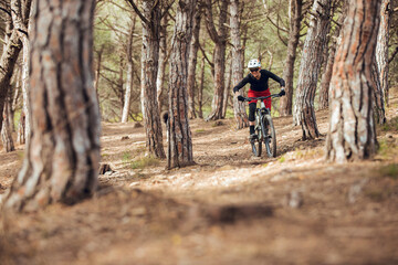 Young girl practicing enduro mtb on trail in the mountains