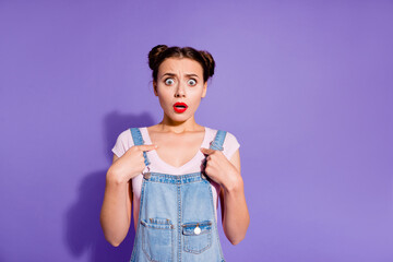 Wall Mural - Portrait of puzzled impressed girl point fingers self stare speechless isolated on purple color background