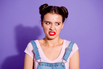 Photo of unsatisfied young person grinning teeth look empty space isolated on violet color background