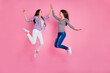 Full length portrait of two excited active people jumping hand give high five isolated on pink color background