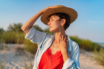 stylish attractive woman on beach in summer style fashion trend outfit happy having fun