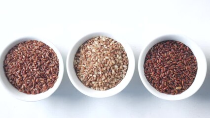 Wall Mural - four different types of rice in a bowl on white background 