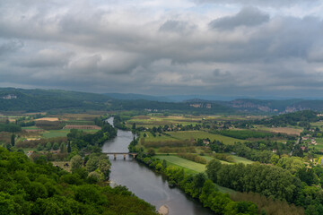 Sticker - view of the picturesque Dordogne Valley with river and bridge in dense green summer forest