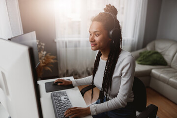 Wall Mural - portrait of smiled beautiful woman developer working indoor, stylish young female using computer