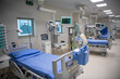 © Dragan - Empty Modern technology in intensive care unit room with different equipment and devices, beds and pillows.