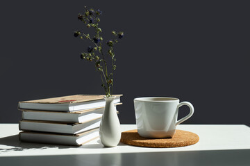 Sticker - books, a mug of tea and a vase of flowers.