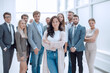 © ASDF - confident young woman standing in front of the business team.