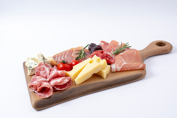 Wall Mural - Appetizers table with different antipasti, charcuterie, snacks and cheese. Buffet party. Wooden cutting board isolated on white background, top view