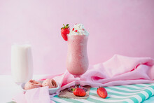 decorated strawberry ice cream milkshake with pink color background.different angles view