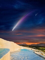 Wall Mural - fantastic unreal image: giant colorful comet in dark starry sky over white pamukkale, turkey
