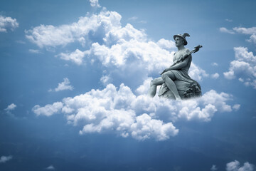 Ancient statue of the antique god of commerce, merchants and travelers Hermes (Mercury) in the clouds.