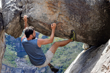 person climbing a rock