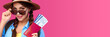 © khmelev - Smiling caucasian woman insunglasses holding passport with travel ticket inside over pink isolate background. Studoi shot