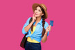 © khmelev - Smiling caucasian woman holding credit card isolated on pink background. Online shopping, e-commerce, internet banking, spending money, enjoying life concepts