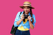 © khmelev - Tourism concept. Happy caucasian woman tourist in summer casual clothing holding photo camera, isolated on pink background with copy space