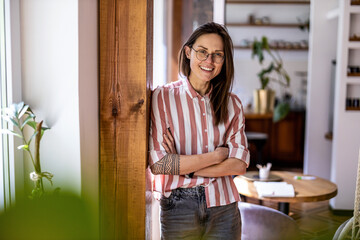 Portrait of a young woman standing in her home
