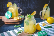 Iced Lemonade In Glass Glass Garnished With Mint And Lemon Wedges
