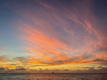 Orange And Red Sky After Sunset In Key West, Florida With Water And Sailboat In View
