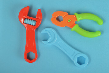 Top view of hammer, wrench and pliers isolated on a blue background