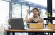 © wichayada - Happy young Asian woman entrepreneur, Smile for sales success after checking order from online shopping store at home office, Concept of merchant business online and eCommerce