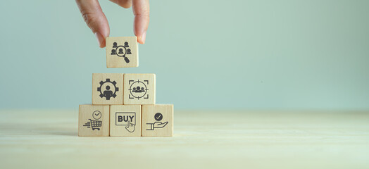 Customer behavior analytics. Marketing concept. Consumer buying decision.  Holding wooden cubes with customer analytics icon standing with consumer behaviors icon; when, how they buy and expectation.