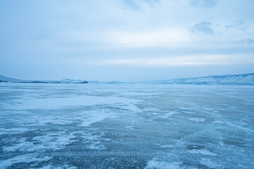  Baikal Lake. Unusual winter landscape. White layered bubbles in transparent ice