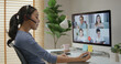 © ChayTee - Happy smile asia young woman learn mba college class on wifi webcam video call in desktop pc screen with cowork friend workforce group talk in sale report. Smart job work at home for staff workspace.